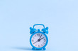 © zphoto83 - Small alarm clock on blue background