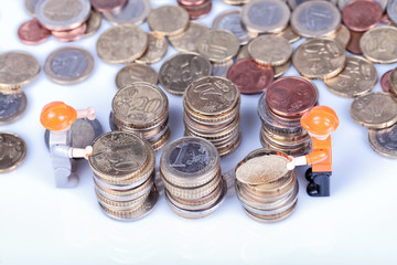 Two miniatures of workers collecting coins