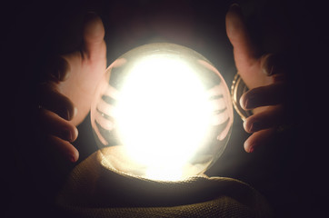 Fortune teller reading future with crystal ball. Seance concept.