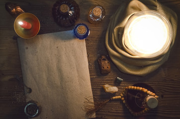 Wall Mural - Crystal ball and ancient magic blank scroll page with copy space on fortune teller magic desk table background. Seance concept.