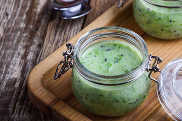 Poster - Healthy green yogurt sauce in glass jar close up