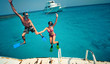 Happy young couple having snorkeling and beach fun on the yacht vacation honeymoon travel holidays. Caucasian woman and man playing playful enjoying love. Multiracial couple