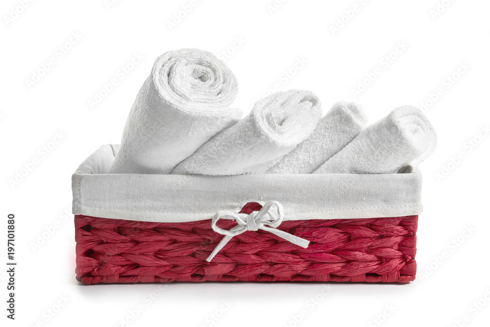 Wicker basket with clean terry towels on white background