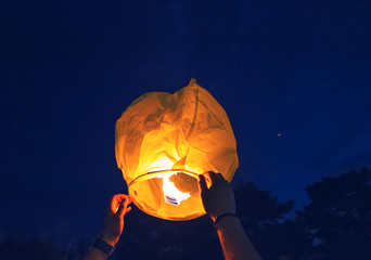 People is launching sky lantern to the sky