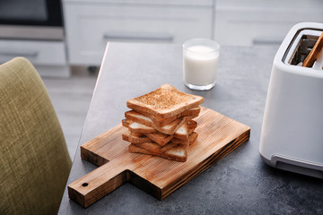 Sticker - Wooden board with toasted bread and glass of milk on table