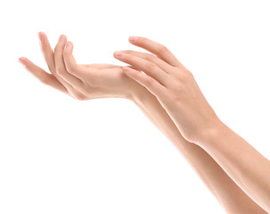 Young woman applying cream onto hands on white background