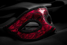 Sexuallity, Sensuality And Eroticism Concept With Close Up On A Beautiful Red Lace Masquerade Vintage Gothic Mask On Black Silk