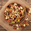 Mixed nuts in wooden bowl with square format
