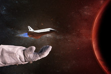 The Shuttle In The Hands Of The Astronaut Opposite The Red Planet. Elements Of This Image Furnished By NASA.