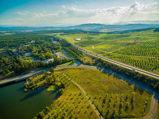 aerial view of tuggeranong parkway passing near national arboretum in canberra, australia