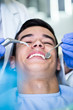 © Dusko - Young attractive man receiving a dental treatment. Close up shot.