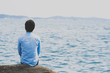 © MrWirot - Young wearing a blue shirt, sitting alone on a lonely sea.