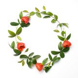 Fototapeta Na ścianę - Flowers composition. Wreath made of orange flowers and green leaves on white background. Flat lay, top view