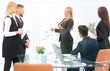 © ASDF - business woman doing a presentation to his business team.