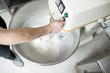 © rh2010 - Mixing a dough for bread baking with professional kneader machine at the manufacturing