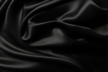 Elegant black satin silk with waves, texture background
