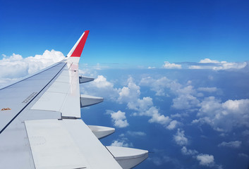 Evening wing of airplane and cloudy sky