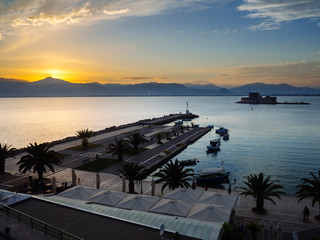 a panoramic view of the old harbour of nafplio with the historical water castle of bourtzi in the mi