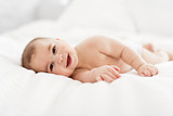 Portrait of a baby boy on the bed in bedroom