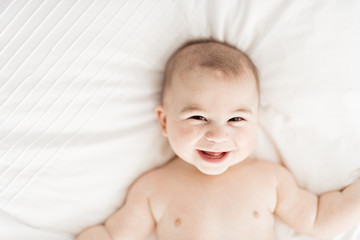 Wall Mural - Portrait of a baby boy on the bed in bedroom