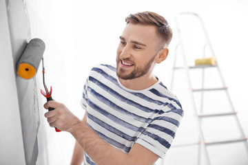 Sticker - Young man painting wall in room