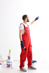 Wall Mural - Portrait of male decorator with brush indoors