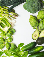 Wall Mural - Green vegetables and herbs assortment on a white background. Healthy food. Top view, frame