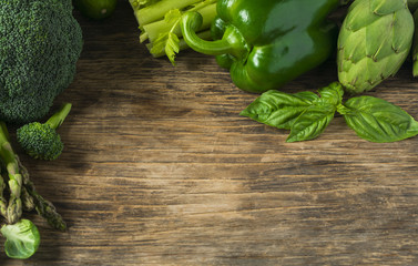 Poster - Green vegetables on a wooden background. Healthy food.