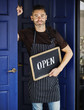 © Rawpixel.com - A cheerful small business owner with open sign