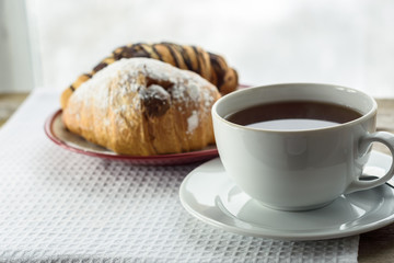 Cup of tea and croissants. closeup