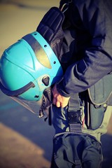 Wall Mural - blue helmet of a policeman in riot gear during the uprising with photo effect