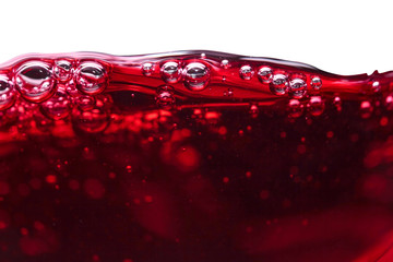 Red wine on white background.