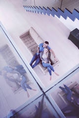 Wall Mural - youg couple in living room with tablet top view