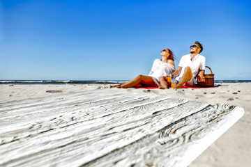 Summer desk of free space and two lovers on beach. 