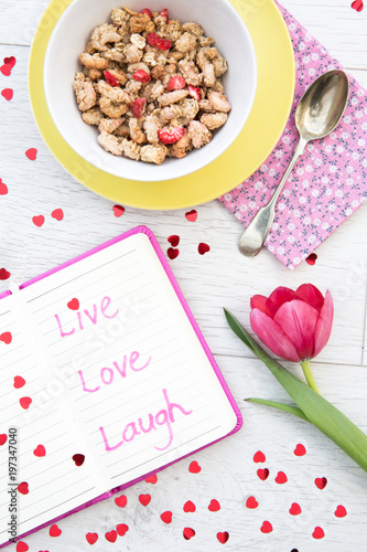 Looking down from above onto a white breakfast table with a notebook and inspira Poster