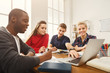 © Prostock-studio - Group of diverse students studying at wooden table