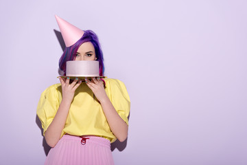 Wall Mural - attractive young woman with colorful hair covering face with birthday cake