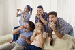 © Studio Romantic - A group of friends eating pizza while sitting on the couch in the room.