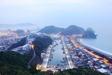 Wall Mural - Aerial view of misty sunrise at Nanfangao harbor, a fishing village northeast to Taipei Taiwan ~ Magnificent sunrise scenery of beautiful coastline on a foggy morning