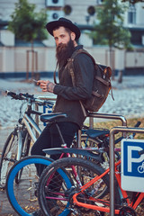 Wall Mural - A handsome hipster traveler with a stylish beard and tattoo on h