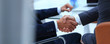 © ASDF - handshake of business partners on blurred background