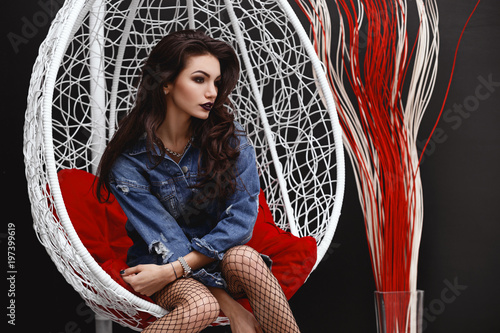 High Sexy Brunette In The Style Of Rockstar Fashion Punk Girl In A Fashionable Denim Jacket Photosession In The Interior Girl Posing As A Rock N Roll Star Buy This Stock Photo And