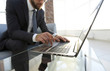 © ASDF - Portrait of successful businessman working in modern office