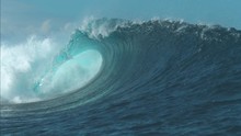 SLOW MOTION CLOSE UP: Breathtaking Turquoise Barrel Wave Crashes On A Perfect Summer Day At The Sea. Beautiful Glistening Tube Wave Crashes In The Middle Of The Breathtaking Ocean. Powerful Water Rush