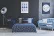 Blue sofa in bedroom interior