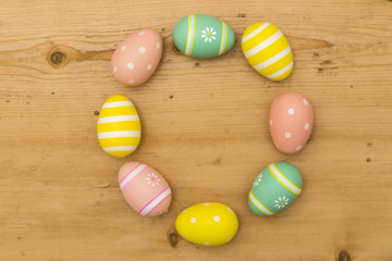 Wall Mural - Painted Easter eggs on a wooden background