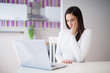 © Dusan Petkovic - Young beautiful serious girl is sitting at the kitchen table and is worried about what she sees on a laptop.