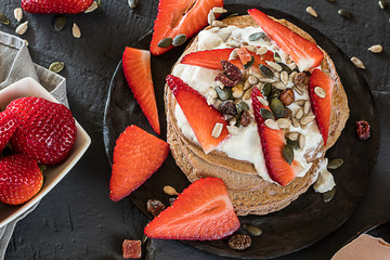 Delicious pancakes with yogurt strawberries and seeds