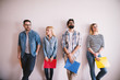 © Dusan Petkovic - Group of young stylish people leaning against the wall bored before a job interview with folders in hands in the waiting room.