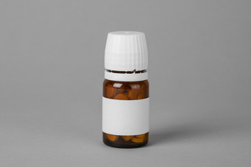 Wall Mural - Bottle with pills on a gray background. Copy space for text